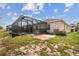 Spacious backyard with a screened-in pool and patio area at 18710 Dobson Dr, Hudson, FL 34667