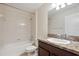 Bright bathroom featuring a shower-tub combo, and a marble countertop vanity at 18710 Dobson Dr, Hudson, FL 34667