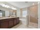 Bright bathroom features double sink vanity, soaking tub and walk-in shower at 18710 Dobson Dr, Hudson, FL 34667
