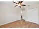 Bedroom boasts wood floors, a ceiling fan, and a double-door closet at 18710 Dobson Dr, Hudson, FL 34667