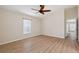 Bright bedroom featuring laminate floors, neutral walls, and a modern ceiling fan at 18710 Dobson Dr, Hudson, FL 34667