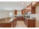 Open kitchen with wood cabinetry, granite counters and stainless appliances, blending style and functionality at 18710 Dobson Dr, Hudson, FL 34667