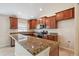 Beautiful kitchen with granite countertops, stainless steel appliances, and wood cabinets at 18710 Dobson Dr, Hudson, FL 34667