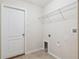 Empty laundry room with tile flooring and white wire shelving at 18710 Dobson Dr, Hudson, FL 34667