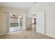 Spacious living area with tile flooring and sliding glass door to the lanai at 18710 Dobson Dr, Hudson, FL 34667