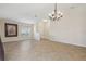 Large living room with tile floors, bright windows and decorative chandelier at 18710 Dobson Dr, Hudson, FL 34667