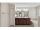 Main bathroom featuring double vanity, soaking tub, and a glass-enclosed shower at 18710 Dobson Dr, Hudson, FL 34667