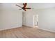 Spacious main bedroom with laminate floors, light walls, and a ceiling fan at 18710 Dobson Dr, Hudson, FL 34667