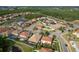 Community aerial view showcasing diverse homes, lush landscaping, and tranquil ponds, offering a serene residential environment at 19082 Umberland Pl, Land O Lakes, FL 34638