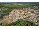 An aerial view of a residential community highlights a home and neighborhood surrounded by nature and ponds at 19082 Umberland Pl, Land O Lakes, FL 34638
