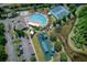 An aerial shot of community amenities including a clubhouse, pool, tennis courts, playground, and lush landscaping at 19082 Umberland Pl, Land O Lakes, FL 34638