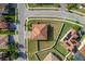 An aerial shot shows a home with a terracotta roof surrounded by a well-kept lawn and a white fence at 19082 Umberland Pl, Land O Lakes, FL 34638