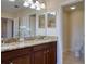 Bright bathroom featuring dual vanity, granite countertops, tile floors, and water closet at 19082 Umberland Pl, Land O Lakes, FL 34638