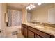 Bathroom with a dual-sink vanity featuring granite countertops and a framed mirror at 19082 Umberland Pl, Land O Lakes, FL 34638