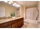 Bathroom featuring a double sink vanity with granite counters, a shower with a curtain and neutral tile flooring at 19082 Umberland Pl, Land O Lakes, FL 34638