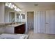 Bright bathroom featuring dual vanity, granite countertops, tile floors, and water closet at 19082 Umberland Pl, Land O Lakes, FL 34638