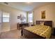 Comfortable bedroom with a full bed, desk, and large window providing ample natural light at 19082 Umberland Pl, Land O Lakes, FL 34638