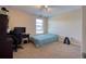 Bedroom with a twin bed, desk, and window, lit by a ceiling fan with blue lights at 19082 Umberland Pl, Land O Lakes, FL 34638