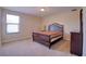 Bedroom features a bed, a window with natural light and a dresser, offering a serene retreat at 19082 Umberland Pl, Land O Lakes, FL 34638