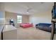Cozy bedroom featuring a bed, a sofa, a lighted makeup table and a window, creating a comfortable and stylish space at 19082 Umberland Pl, Land O Lakes, FL 34638