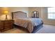 Elegant bedroom featuring a luxurious bed, a vanity, and a nightstand, providing a serene and stylish retreat at 19082 Umberland Pl, Land O Lakes, FL 34638