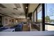 Spacious clubhouse with comfortable seating, tables, and a view of the pool outside the large windows at 19082 Umberland Pl, Land O Lakes, FL 34638