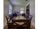 Traditional dining area featuring a sleek table, chair set, and abundant natural light at 19082 Umberland Pl, Land O Lakes, FL 34638