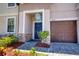 Inviting front entrance with a stylish blue door, stone accents, and a well-maintained walkway at 19082 Umberland Pl, Land O Lakes, FL 34638