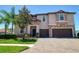 Inviting two-story home showcasing a paver driveway and well-manicured landscaping at 19082 Umberland Pl, Land O Lakes, FL 34638
