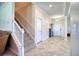 Bright hallway featuring stairs, neutral walls, and tile flooring at 19082 Umberland Pl, Land O Lakes, FL 34638