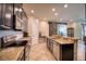 Bright kitchen featuring stainless steel appliances, granite countertops and a view into the living room at 19082 Umberland Pl, Land O Lakes, FL 34638