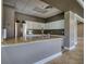 Clubhouse kitchen with granite countertops, stainless steel appliances, and white cabinetry at 19082 Umberland Pl, Land O Lakes, FL 34638