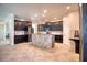 Modern kitchen featuring granite countertops, stainless steel appliances, and an island with stone accents at 19082 Umberland Pl, Land O Lakes, FL 34638