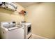 Laundry room featuring a modern washer and dryer, with a wire rack for storage above at 19082 Umberland Pl, Land O Lakes, FL 34638