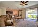 Comfortable living room with a large sectional sofa and sliding glass doors leading to the backyard at 19082 Umberland Pl, Land O Lakes, FL 34638