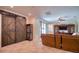 Spacious living area featuring a sliding barn door and a comfortable sofa at 19082 Umberland Pl, Land O Lakes, FL 34638