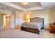 Main bedroom featuring a tray ceiling, and a luxurious bed, offering a peaceful and stylish retreat at 19082 Umberland Pl, Land O Lakes, FL 34638