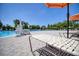 A relaxing view from a lounge chair at the edge of a spacious community pool with clear blue water at 19082 Umberland Pl, Land O Lakes, FL 34638