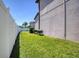Manicured side yard with verdant grass, border fence, and space for gardening at 19082 Umberland Pl, Land O Lakes, FL 34638