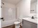 A full bathroom with a shower-tub, white vanity with sink, and wood-look flooring at 20064 Manecke Rd, Brooksville, FL 34601