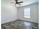 Bedroom with modern ceiling fan, window with blinds, and gray wood-look flooring at 20064 Manecke Rd, Brooksville, FL 34601