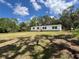 Lovely single-story home featuring a large front yard and shaded by mature trees at 20064 Manecke Rd, Brooksville, FL 34601
