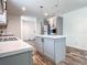 Charming kitchen featuring pendant lighting, stainless steel appliances, and an island with a white countertop at 20064 Manecke Rd, Brooksville, FL 34601