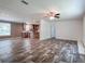 Open-concept living room with hardwood floors, neutral walls, and ample natural light at 20064 Manecke Rd, Brooksville, FL 34601