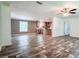 Spacious living area with modern flooring, open layout, and seamless flow to kitchen at 20064 Manecke Rd, Brooksville, FL 34601