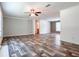 Bright living room showcasing new floors, a ceiling fan, and an open layout at 20064 Manecke Rd, Brooksville, FL 34601