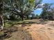 Exterior view of a vacant lot with mature shade trees and new construction at 20064 Manecke Rd, Brooksville, FL 34601
