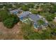 A serene view showcasing a blue building complex surrounded by lush greenery, featuring a communal pool at 2026 Golfview Dr # 2026, Tarpon Springs, FL 34689