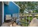 Outdoor balcony offers a great view of the surrounding landscape with seating, a glass table and privacy railing at 2026 Golfview Dr # 2026, Tarpon Springs, FL 34689