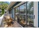 Outdoor balcony features seating, a glass table and an open, screened in view at 2026 Golfview Dr # 2026, Tarpon Springs, FL 34689